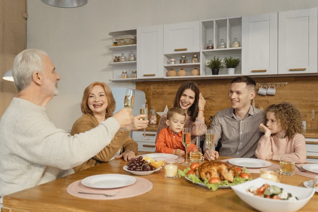 A happy family smiling together at the dinner table